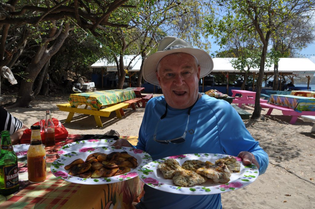 Greg with BBQ chicken and fried plantains